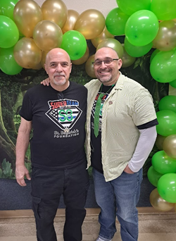 Brad Riccillo along with his father Deacon Ed Riccillo pose for a picture after they both had their heads shaved to help handcuff childhood cancer!