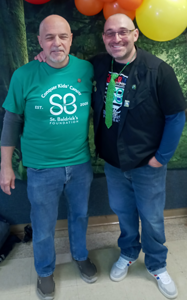 Brad Riccillo along with his father Deacon Ed Riccillo pose for a picture after they both had their heads shaved to help handcuff childhood cancer!