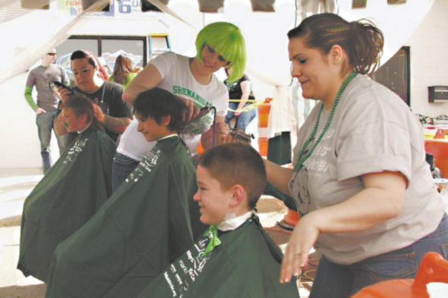 Children get their heads shaved at a previous St. Baldrick's event [FILE PHOTO]
