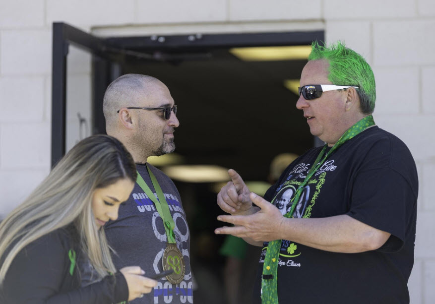 Event Organizer Grant Shay, right, speaks with first place fundraiser Brad Riccillo and volunteer Kendra Davis on Saturday at Jimmy's Tavern. [CHIEFTAIN PHOTO/ZACHARY ALLEN]