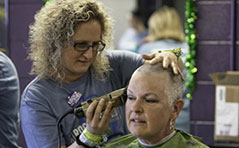 Six-year participant, Leah Bosley, gets her hair shorn by Misty Duncan on Saturday at Jimmy's Tavern in Pueblo West to raise money for the St. Baldrick's Foundation. [CHIEFTAIN PHOTO/ZACHARY ALLEN]